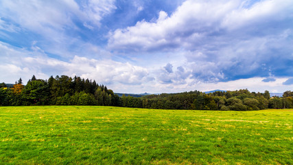 Wall Mural - beautiful landscape. green field and clouds