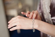 © Olga Mishyna - Bride's hands with simple manicure buttons bracelet