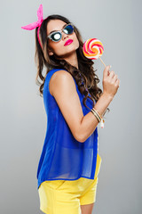 Poster - Girl in blue and yellow holding lollipop