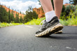 © Nomad_Soul - Legs in sport shoes on road at sunset closeup.