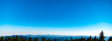 Landscape View Of Tree Line In Foreground With The Cascade Range, Including Mt Jefferson, In The Distance