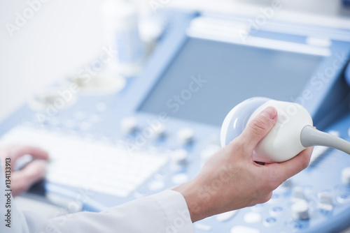 Fotografia, Obraz young woman doctor's hands close up preparing for an ultrasound device scan