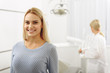 © Yakobchuk Olena - Satisfied woman leaving dental room