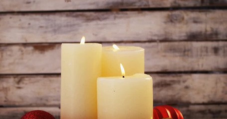 Poster - Close-up of burning candles with christmas decoration on wooden plank