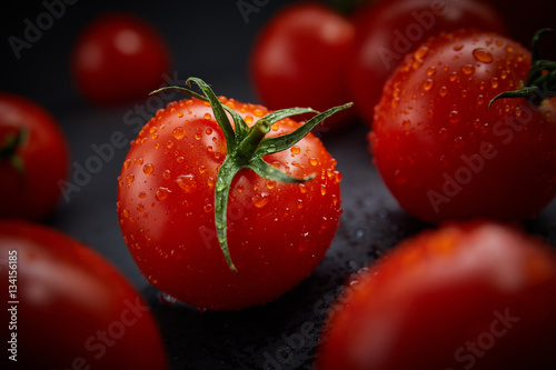Fotografía Fresh cherry tomatoes on black background