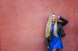 © Africa Studio - Beautiful young woman outdoors near grunge wall