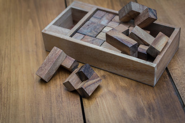 Wooden Block Brain Teaser Puzzle on Wood Background Spread Out