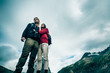 Young Couple Standing On The Mountain's Peak