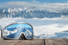 Ski Goggles With Reflection Of Mountains.