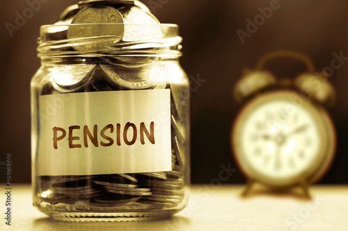 Fotomural Close up Coins in glass jar for giving and pension concept , dar