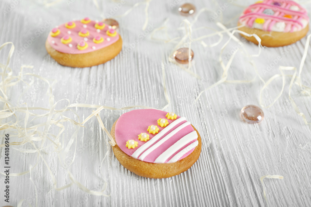 Creative Easter cookies and decorations on wooden table, closeup