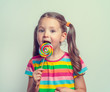 © Myst - beautiful cute little girl eating lollipop