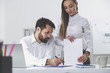 © ImageFlow - Man signing documents given by woman