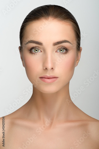 Young girl with big eyes and dark eyebrows, naked shoulders ...
