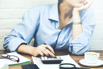 Wall Mural - female accountant or banker making calculations