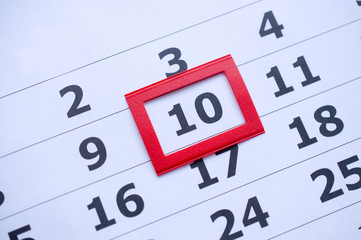 White paper calendar with the number 10  in the red box