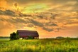 Wooden Barn Sunset. Rural sunset with an abandoned barn surrounded by farm fields.