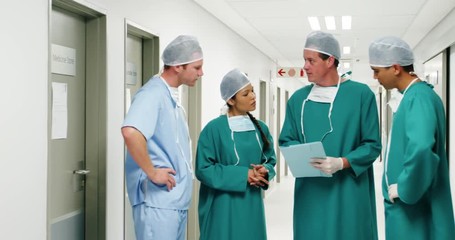 Poster - Male surgeons discussing over medical reports
