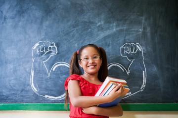 Wall Mural - Hispanic Girl Holding Books In Classroom And Smiling