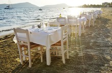 Table Set On The Beach At A Traditional Greek Taverna Restaurant In Messenia, Greece