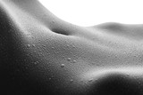 Beautiful slim female body with drops of water