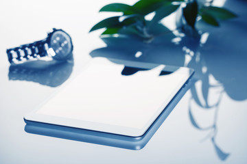 Business still-life with tablet computer and clock toned in blue