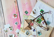Postage Stamps, Envelopes And Glasses On A Wooden Background.