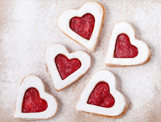 Wall Mural - Cookie on the valentine's day. Lovely heart shaped linzer cookies with strawberry jam a shortcake dough for valentines. Homemade baking. Flat lay. Top view.