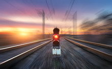 Railway Station And Semaphore With Motion Blur Effect Against Colorful Sky With Clouds At Sunset. Concept Industrial Landscape. Railroad. Railway Platform With Traffic Light. Heavy Industry Background