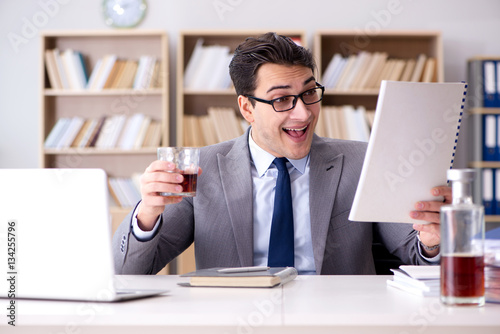 Fotografia, Obraz Young businessman drinking from stress