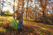© RooM The Agency - Young boy raking autumn leaves