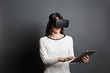 © Manuel - young woman using virtual reality glasses and a tablet computer