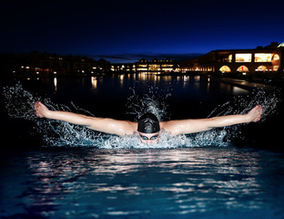 Swimming butterfly isolated dark background