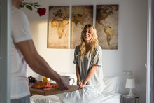 Couple With Surprise Breakfast On Bed