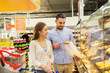 © Syda Productions - happy couple with shopping cart at grocery store