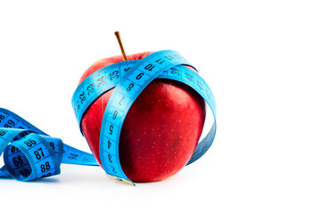 Fresh apple with measuring tape 