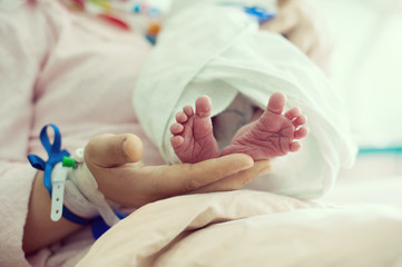 Wall Mural - Newborn baby in hospital with id ribbon on his hand