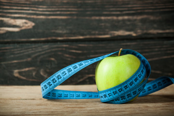 Fresh apple with measuring tape 