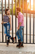 Couple on inline skates standing. Young woman looking at man. Date of active people.