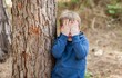 © Roman Yanushevsky - Little Caucasian boy closing his face with hands as if playing hide and seek or scared of something. Hiding face. Closed face.