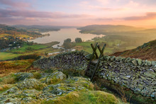 Beautiful Sunset Over Windermere In The Lake District With A Stile And Stone Wall In The Foreground.