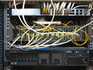 server rack with internet patch cord cables connected to panel