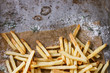 © Natasha Breen - Fast food french fries potatoes with skin served with salt and herbs on baking paper over old rusty metal background. Top view, space for text