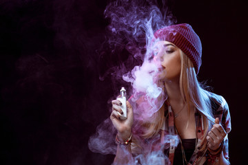 young woman smoking electronic cigarette