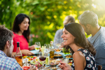 Poster - Group of friends lunching around a table on a terrace