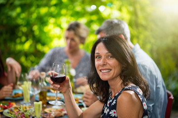 Wall Mural - beautiful woman lunching with friends on a terrace table