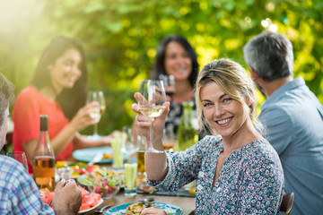 beautiful woman lunching with friends on a terrace table