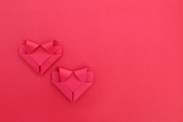 Poster - two folding red paper hearts on red for pattern and background