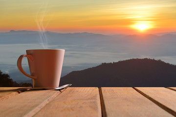 Wall Mural - Morning cup of coffee or tea with mountain background at sunrise