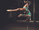 Beautiful woman performing pole dance on pole